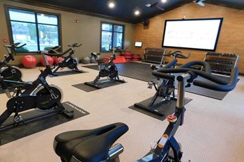 A room filled with lots of different types of exercise equipment